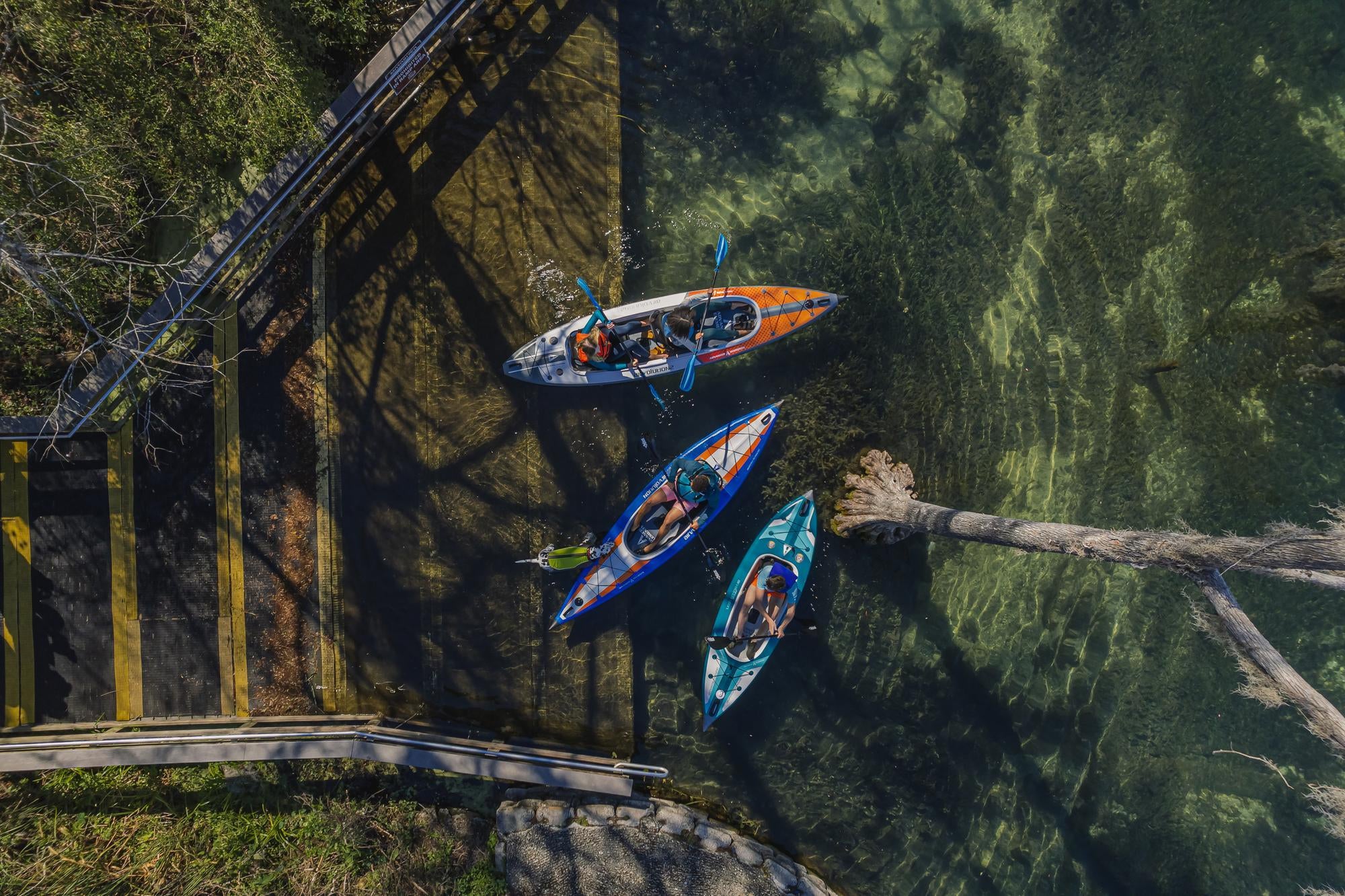 Aerial view of people kayaking on calm water