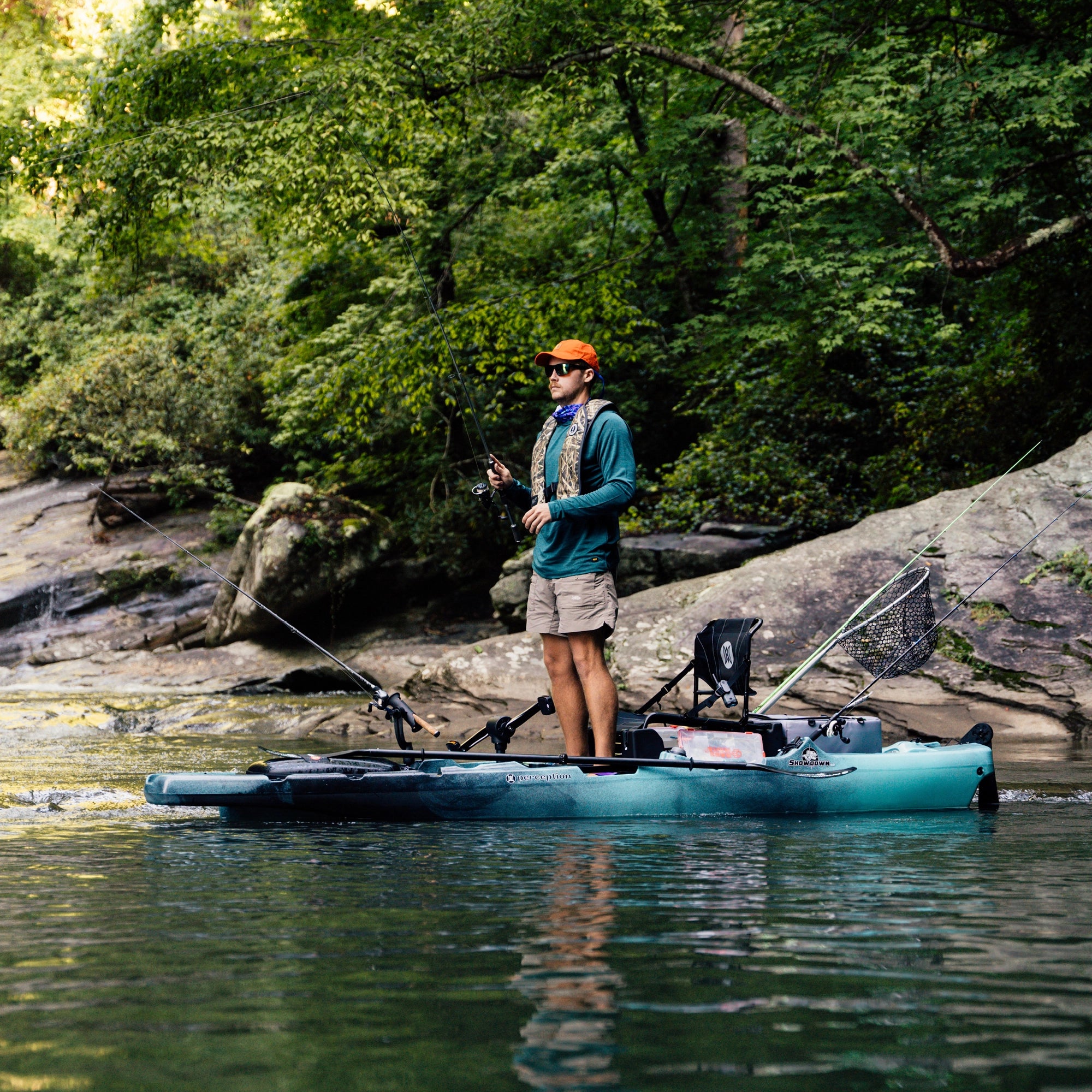 Man standing and fishing from a boat on calm water during an outdoor fishing adventure