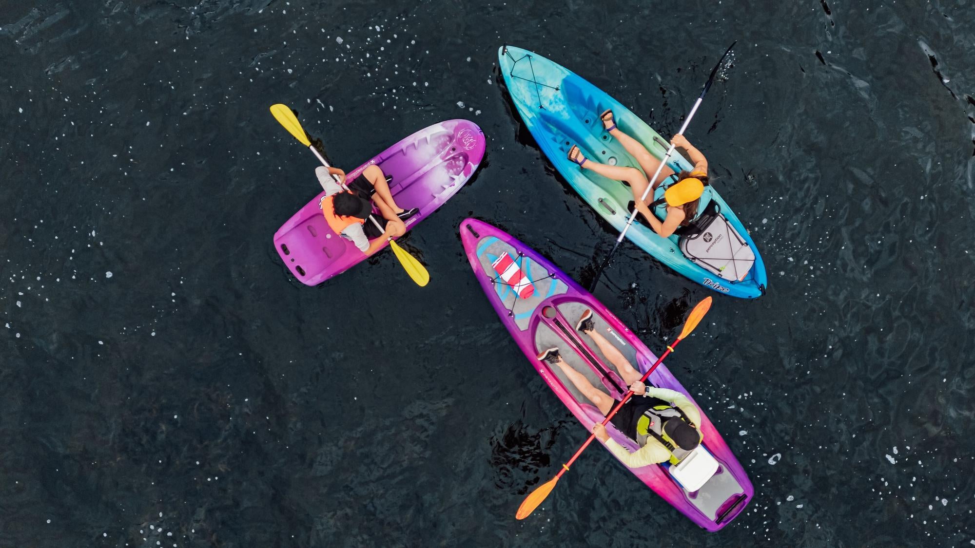 Friends enjoying a relaxing kayaking adventure on Perception Kayaks in calm wate